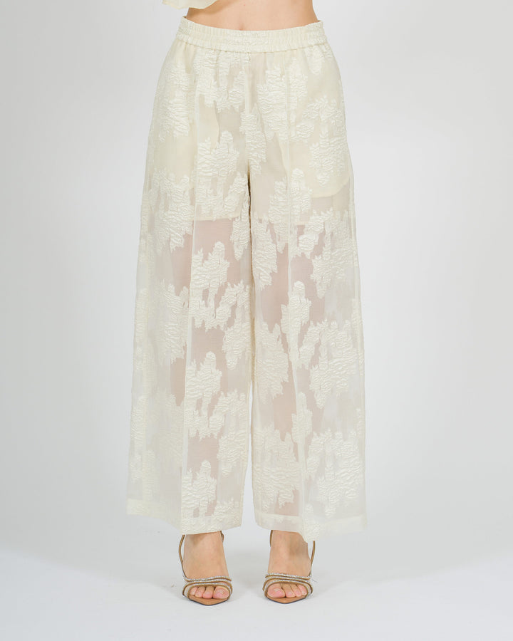 Pantaloni gaucho larghi panna con trasparenze e fantasia floreale tono su tono 