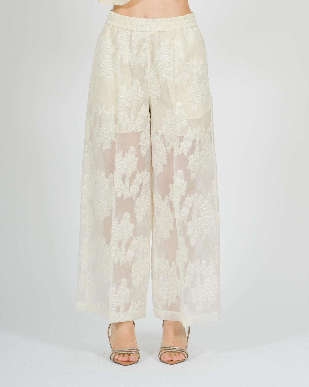 Pantaloni gaucho larghi panna con trasparenze e fantasia floreale tono su tono 