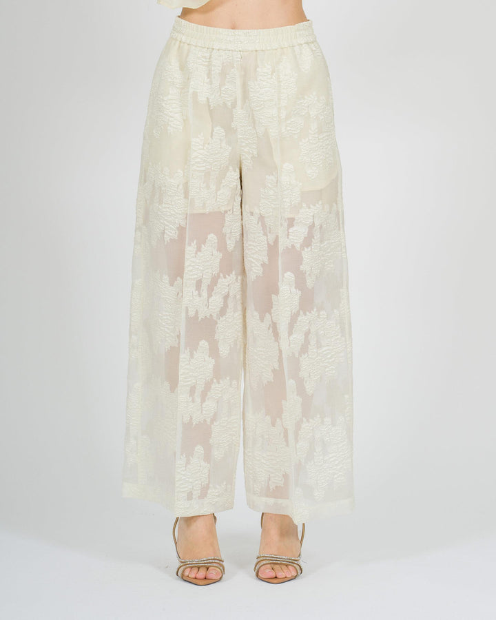 Pantaloni gaucho larghi panna con trasparenze e fantasia floreale tono su tono 